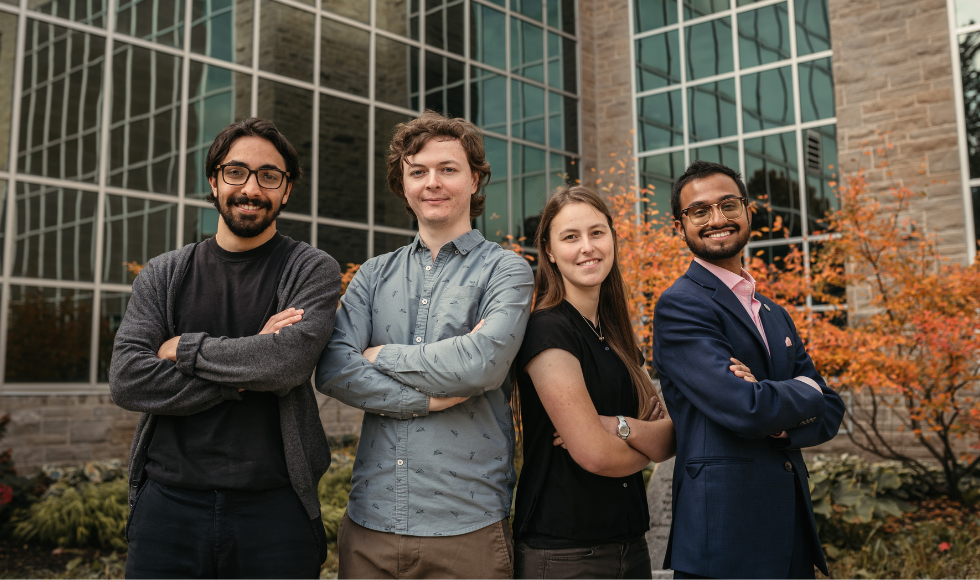 Eden Lazar, Clayton MacNeil, Caitlyn Kuzler and Afeef Khan standing beside each other outdoors posing for a photo. They all have their arms crossed.