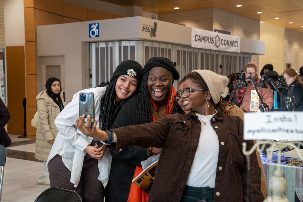 A group of students take a selfie at the Black Expo