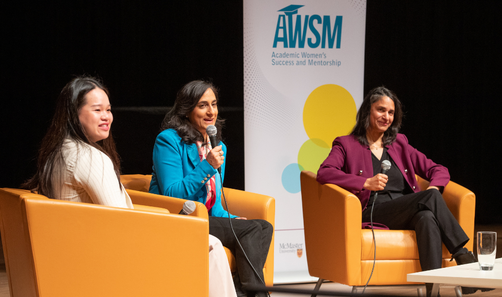 3 women seated in armchairs in front of a banner that reads AWSM