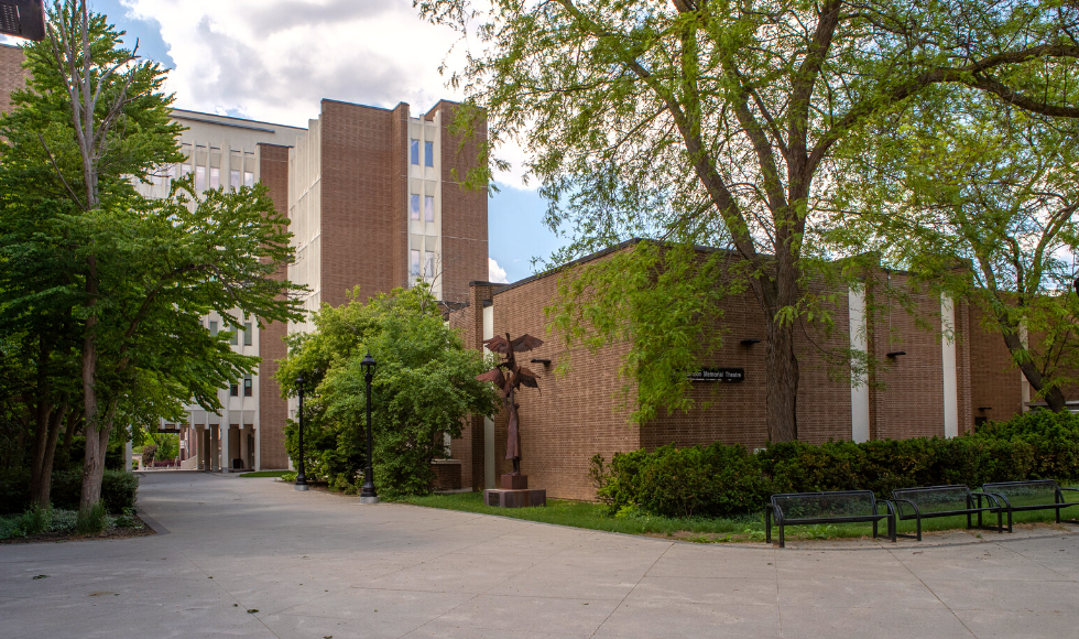 Exterior of Chester New Hall and a sculpture outside it, seen from a spot outside the Student Centre in the Arts Quad.