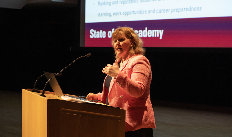 Susan Tighe speaking into a microphone attached to a podium