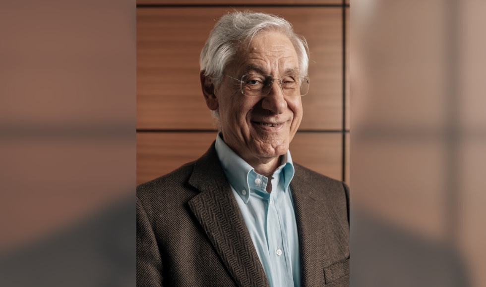 Smiling Headshot of Joe Liburdi in his 70s, in a shirt and jacket.