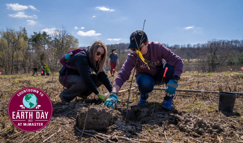 Two students planting a tree