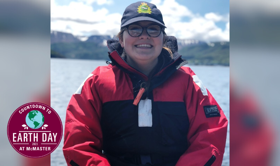 Emily Robson smiling at the camera. There is a large body of water behind her.