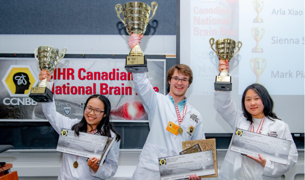 Sienna Su, Mark Piasecki, Arla Xiao hold up their Brain Bee trophies