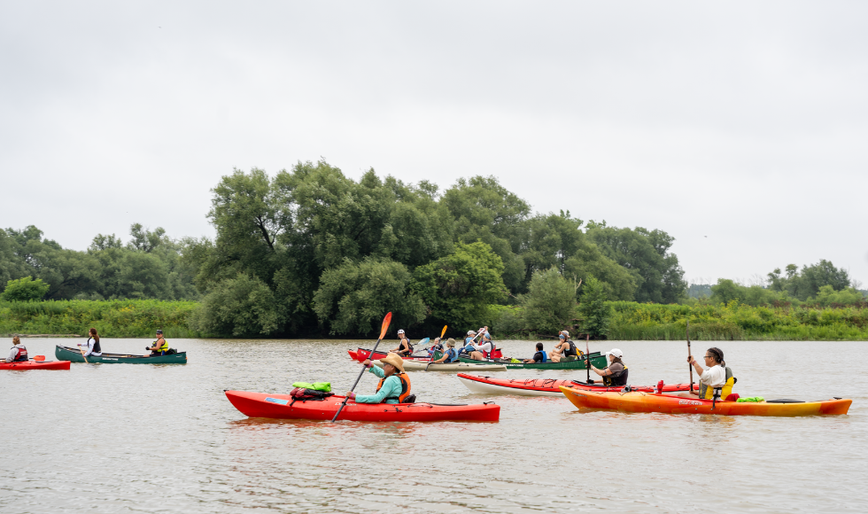 Many paddlers in kayaks and canoes are out on the Grand River