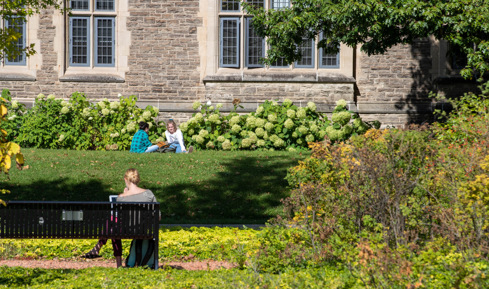 Students sitting near university hall