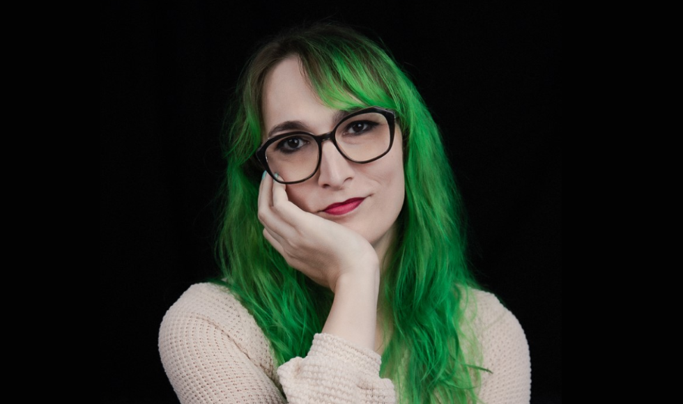 A head and shoulders shot of Paige Maylott, with her chin resting on her hands