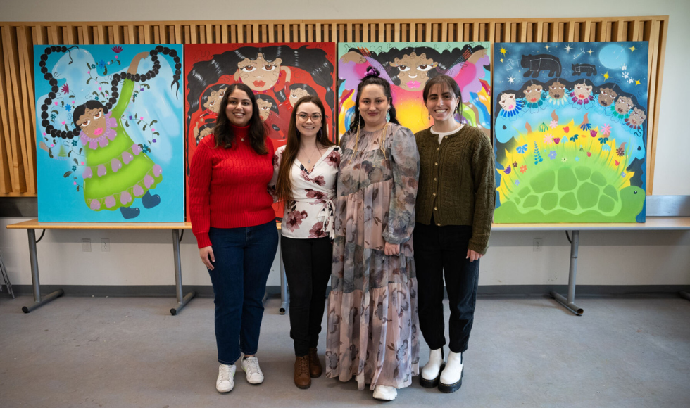 Image of Brooke Fearns and students standing infront of the murals