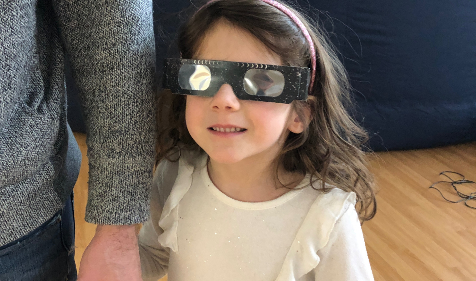 Image of Ella with solar glasses on