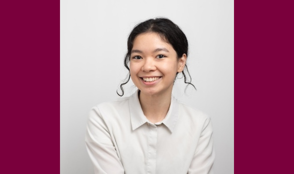 Smiling headshot of Fei Mu against a white backdrop, wearing a light-coloured shirt