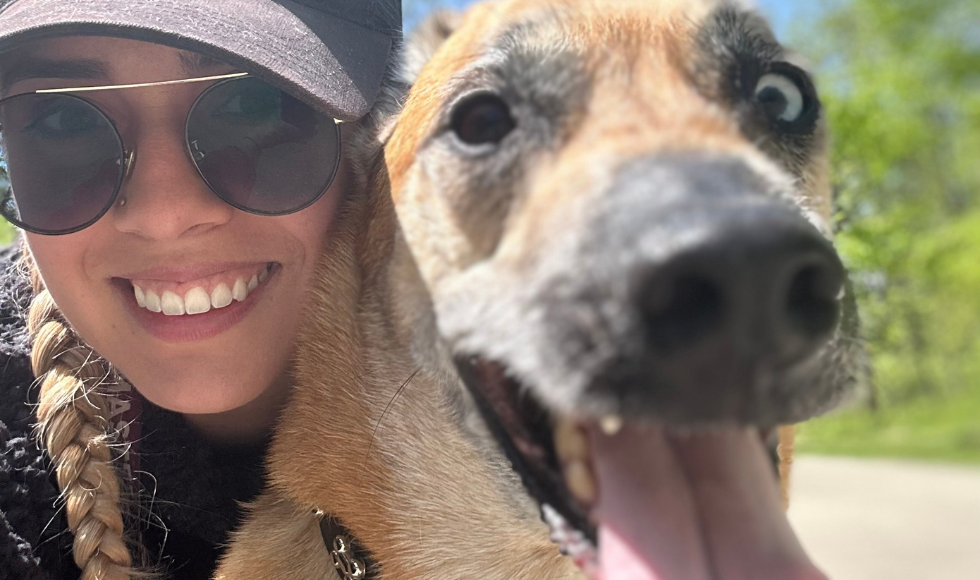 A tight shot of the faces of a woman and dog