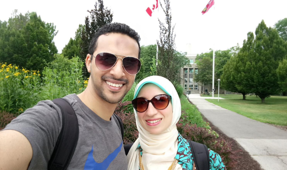 A selfie of Ahmed Mohamadean and Esraa Abdelhalim. They are wearing sunglasses and standing outdoors on McMaster’s campus.