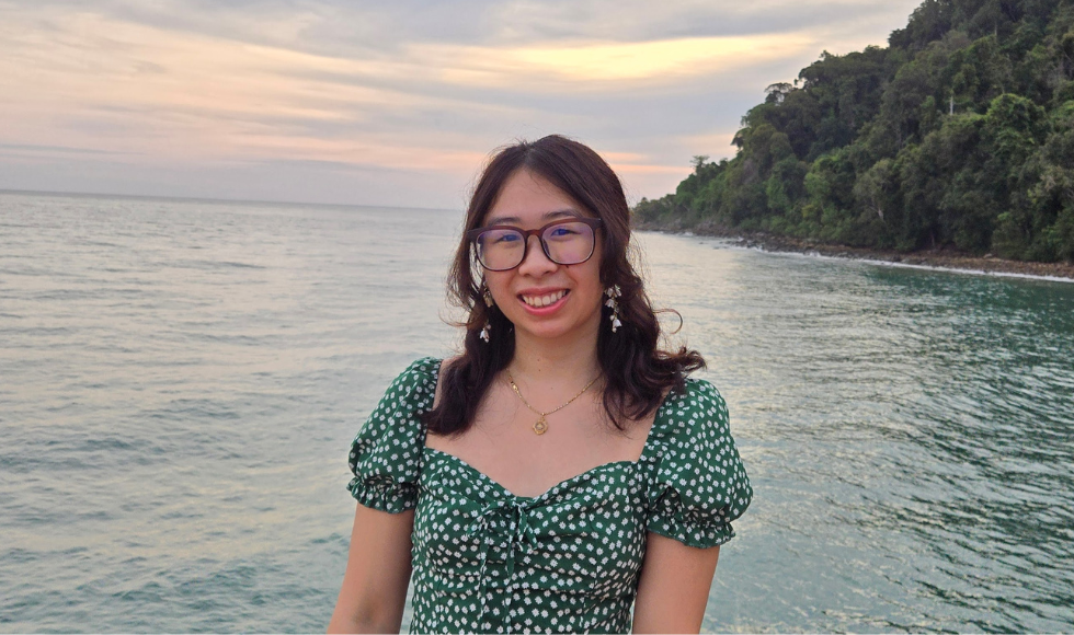 A headshot of Sheridan Fong. She is standing in front of a body of water.