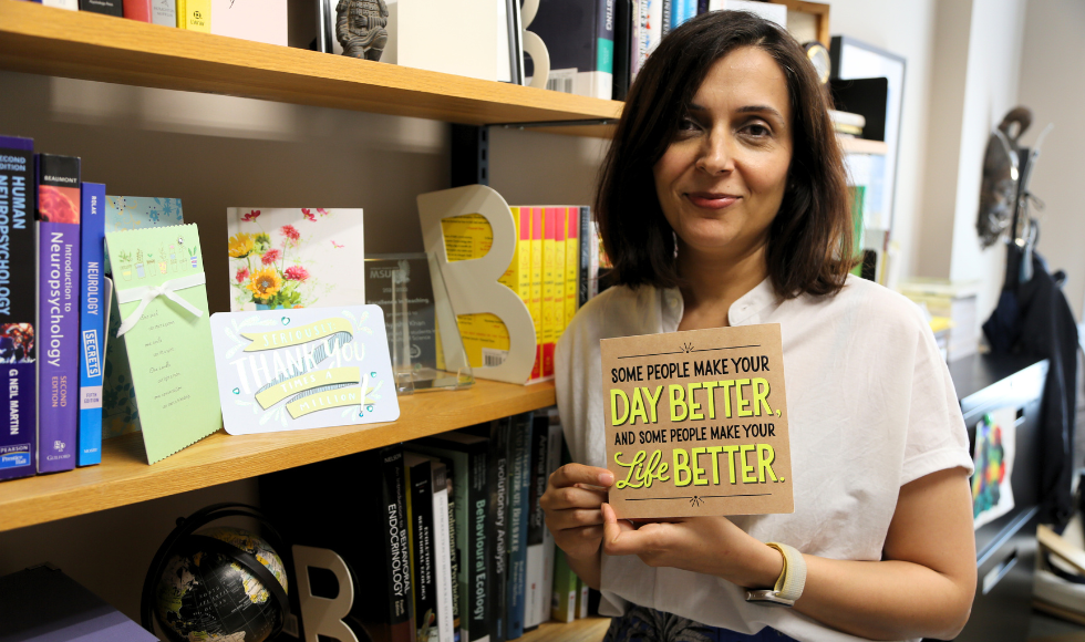 Professor Ayesha Khan holds up a card that reads 