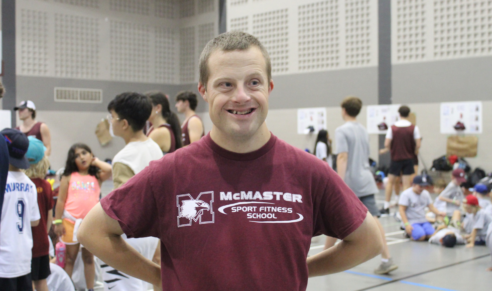 Mark Haggarty smiling while wearing a maroon McMaster Sport Fitness t-shirt