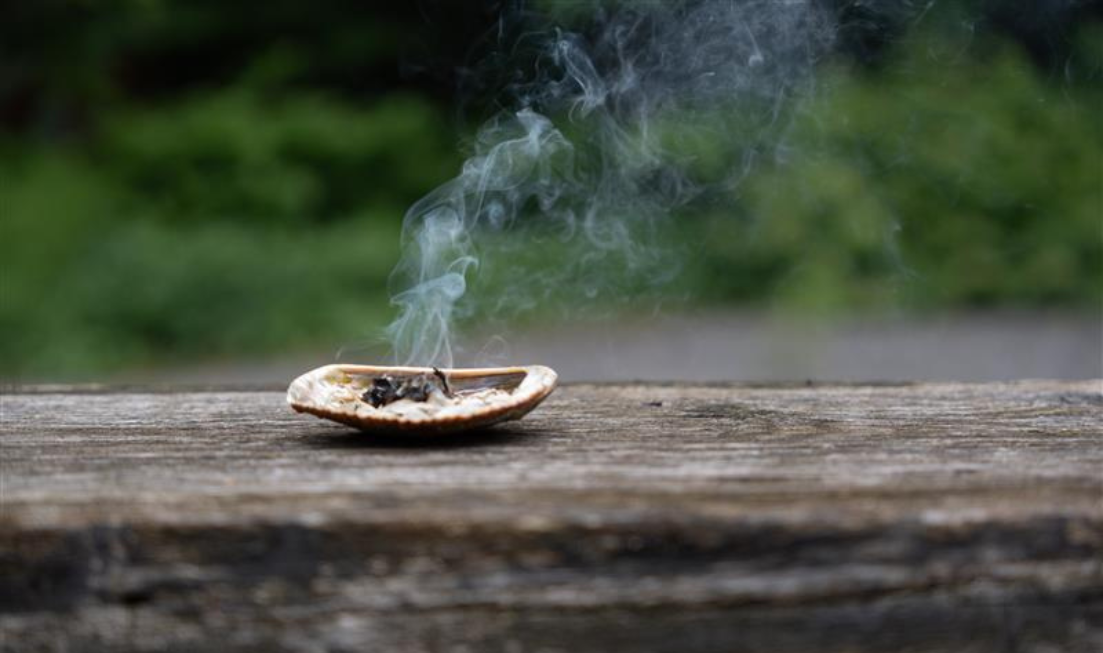 Smoke from medicines burning in a shell rises up into the air.