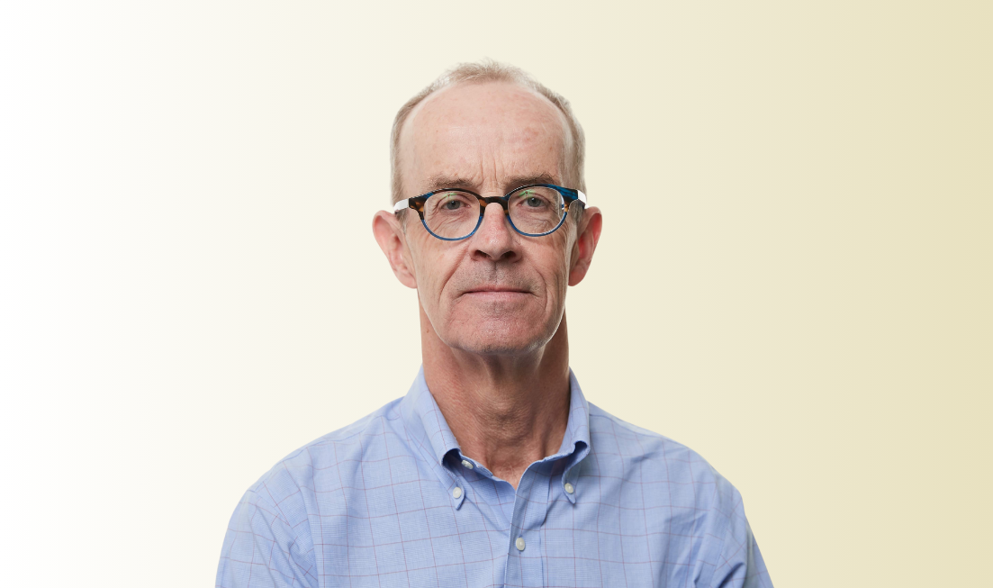 Headshot of Stephen Jones, wearing a light blue shirt and glasses, against a light-coloured background.