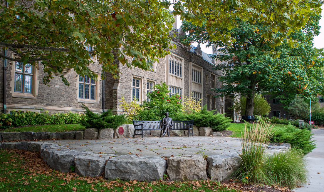 The metal statue of Senator McMaster in front of University Hall in the fall.