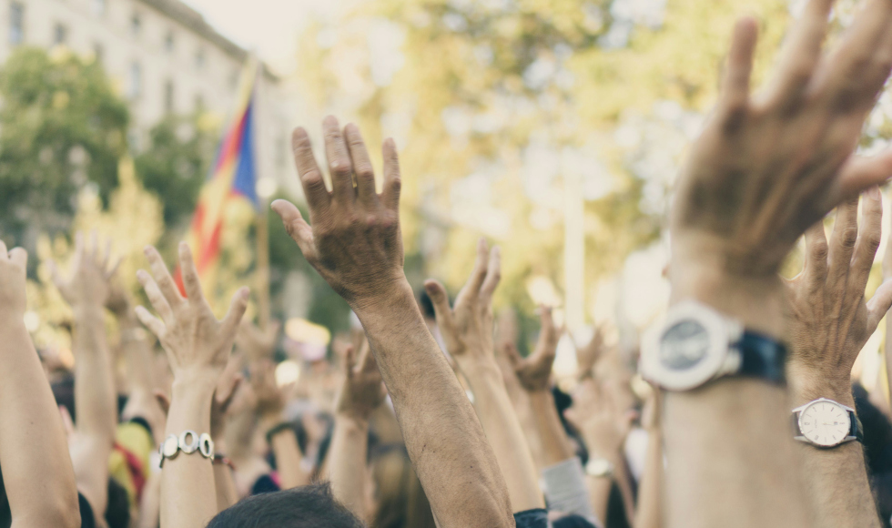 group of people raising their hands