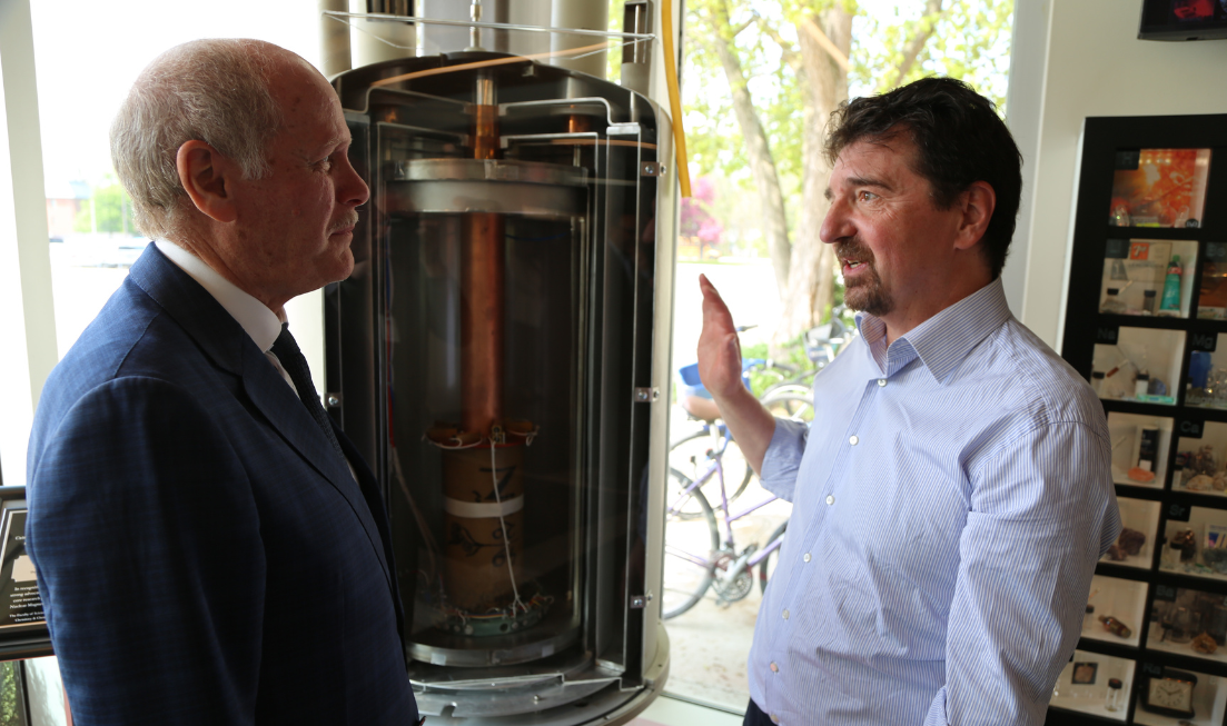 David Farrar and Bob Berno talk at the dedication of the superconducting magnet cross-section.