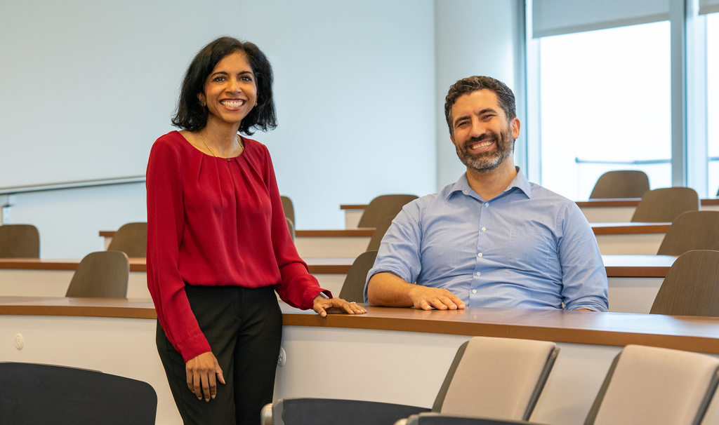 Two smiling professors in a classroom at the McMaster Digital Transformation Research Centre.